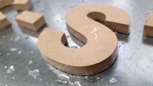 Water Jet Cutter cuts letters from tiles