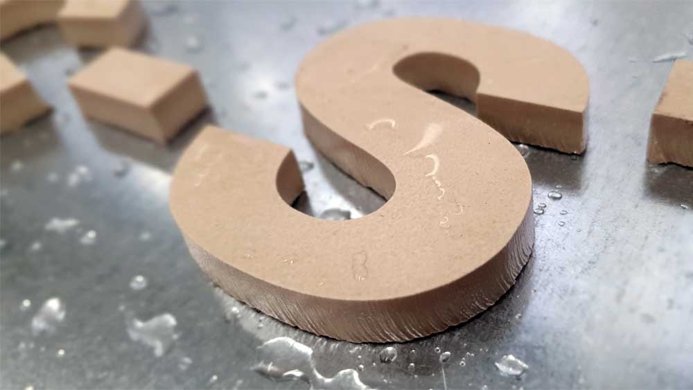 Water Jet Cutting of letters in tiles